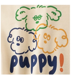 Close-up of three colorful cartoon dogs and puppy text on beige cotton T-shirt fabric