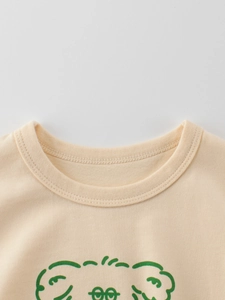 Kids cotton t-shirt with cartoon puppy print and ribbed crew neck in soft beige color