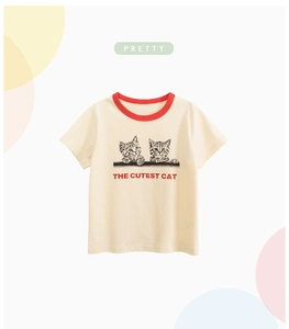 Close-up of cream kids T-shirt featuring cute cat prints and a red ribbed crew neck