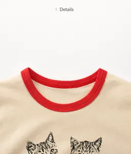 Detail of red ribbed crew neck on a cream cotton cat print t-shirt for girls
