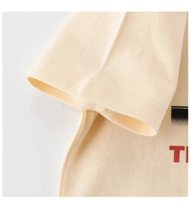 Detailed macro view of beige cotton T-shirt sleeve with high-quality double stitching