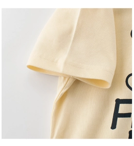 Close-up of double-needle stitching on cream cotton t-shirt sleeve for kids