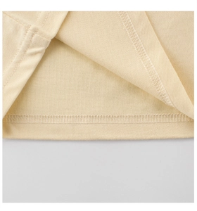 Detailed close-up of double-needle stitching on cream cotton t-shirt hemline