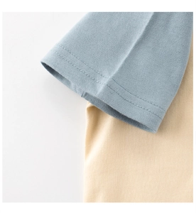 Detailed close-up of double-stitched cuffs on a soft cotton knit baby t-shirt