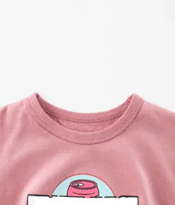 Detail of pink cotton T-shirt featuring a ribbed neckline and fruit juice cartoon print