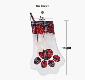 Detailed size display of plaid pet paw Christmas stockings with bone charms and ribbons