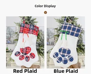 Detail view of red and blue plaid paw-shaped Christmas stockings with festive bows