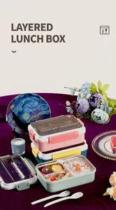 Stack of colorful layered stainless steel lunch boxes with built-in cutlery storage
