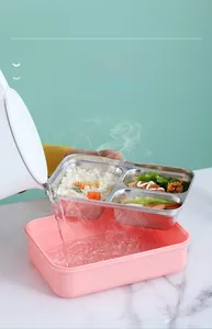 Detail of pouring hot water into the pink bento box base for thermal heating function