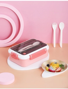 Detail view of pink stainless steel lunch box lid with built-in cutlery storage and clips