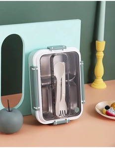 Three-compartment stainless steel bento box with built-in cutlery storage and green lid