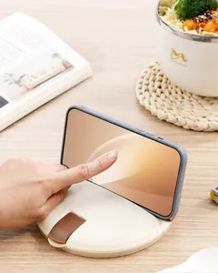 Detail of multi-functional noodle bowl lid with integrated smartphone stand in beige color