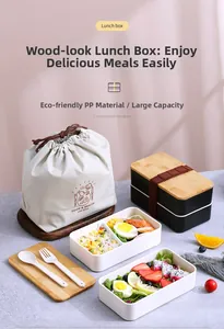 Detail view of dual-layer lunch box with bamboo lid, utensils, and drawstring bag