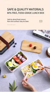 Macro detail of a double-layer black bento box with a bamboo lid and utensils