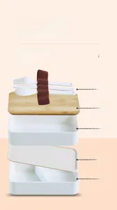 Detailed view showing layers of the double-layer lunch box with bamboo lid and cutlery
