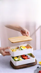 Double-layer bento box with bamboo lid featuring internal compartments for food storage