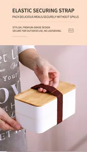 Close-up of double-layer lunch box with natural bamboo lid and elastic strap detail