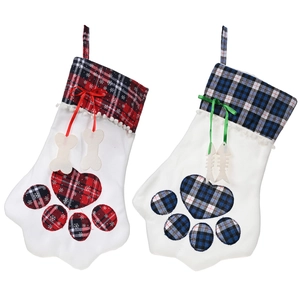 Plaid paw-shaped Christmas stockings in red and blue with festive bone and fish charms