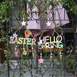 Outdoor close-up of Easter and Hello Spring wooden hanging signs with floral details