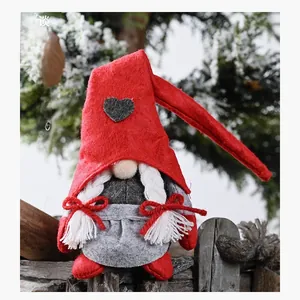 Close-up of female Christmas gnome doll with white braids and red heart patterned hat