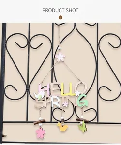 Macro detail of HELLO SPRING wooden hanging sign with bird and floral pendants