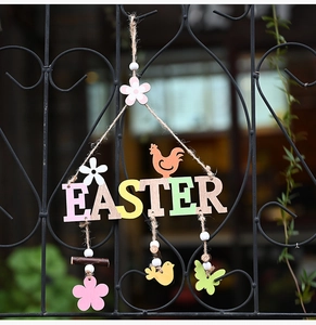 Detail view of Easter wooden letter sign with orange rooster and colorful bird pendants