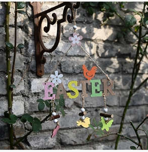 Macro detail of wooden EASTER hanging sign with colorful ornaments on a rustic brick wall