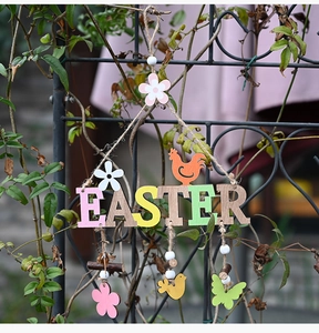 Detail of Easter wooden hanging sign with colorful painted letters and spring animals