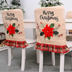 Detail of burlap Christmas chair cover with red flower and green plaid ruffle trim