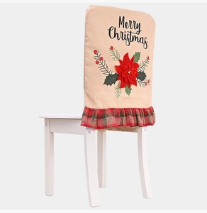 Close-up of burlap Christmas chair cover with poinsettia and Merry Christmas print