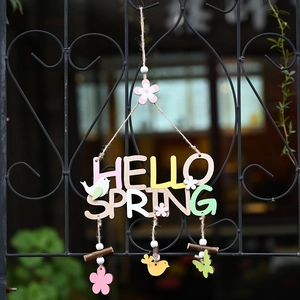 Hello Spring wooden door sign with colorful letters and bird pendants for Easter decor