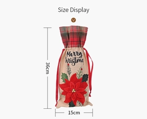 Close-up of burlap wine bottle bag with red flower, plaid trim and size dimensions