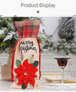 Close-up of burlap wine bottle bag with a 3D red poinsettia flower and Merry Christmas text