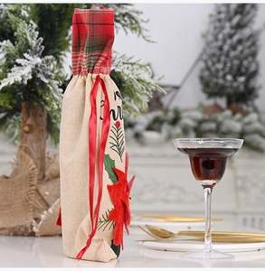 Detail of Christmas burlap wine bag with red poinsettia and festive plaid trim