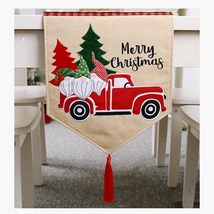 Nahaufnahme des Weihnachtstischläufers aus Sackleinen mit LKW-Druck und festlicher Quaste