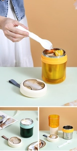 Detail view of portable stainless steel soup cup with lid compartment and folding spoon
