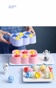Detail of a 6-grid astronaut themed DIY ice cream mold set with round popsicle shapes