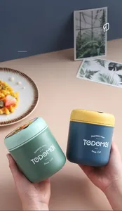 Close-up of portable stainless steel soup cups in mint green and navy blue for breakfast