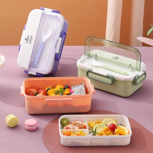 Macro display of multi-layer bento boxes with cutlery and fresh fruit compartments