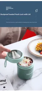 Detail view of mint green stainless steel soup cup with lid and folded spoon