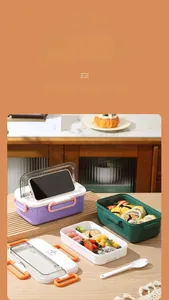 Detail of multi-compartment lunch box lid used as a phone holder for hands-free viewing