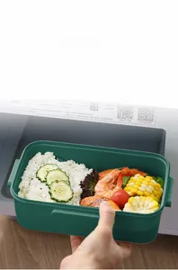 Detail of microwave safe dark green bento box with separate compartments for food