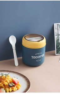 Detailed view of insulated stainless steel soup cup with lid and folding spoon accessory