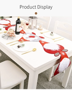 Detailed view of a red and grey Christmas gnome table runner on a holiday dining table