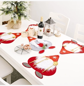 Close-up of festive Christmas gnome table mats made of thick felt with faux fur and sequins