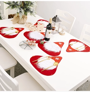 Close-up of a festive red Christmas placemat set with white faux fur beard and snowflake embroidery