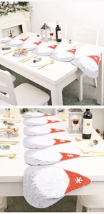 Macro detail of festive Christmas table runner set with sequined hats and plush textures