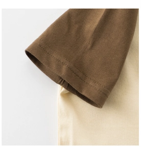 Close-up of raglan sleeve cuffs with double-needle stitching on cotton kids T-shirt