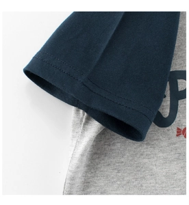 Detail of kids short sleeve T-shirt featuring navy raglan sleeves and gray cotton fabric