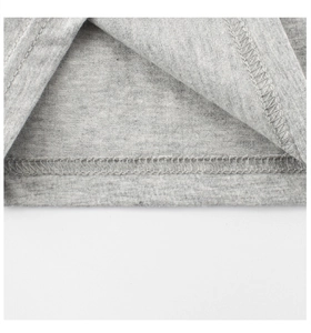 Detail of flatlock stitching on the hem of a heather grey cotton knit t-shirt